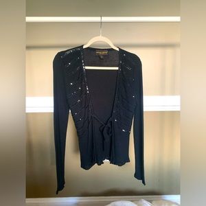 Donna Ricco long sleeved blouse. Tie in the middle. Color is black. Size medium.